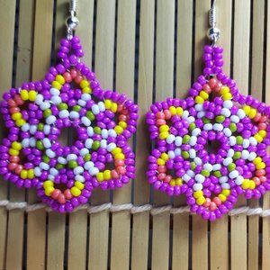 Handcrafted glass bead daisy earrings in purple sunset. 2"